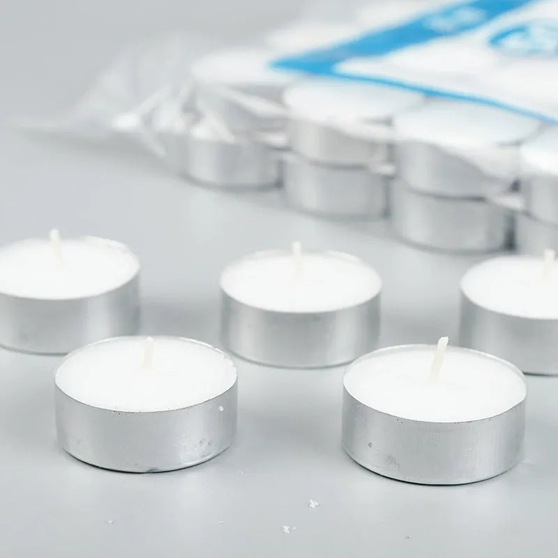 Paraffin tealight candles unlit with smooth wax tops and cotton wicks