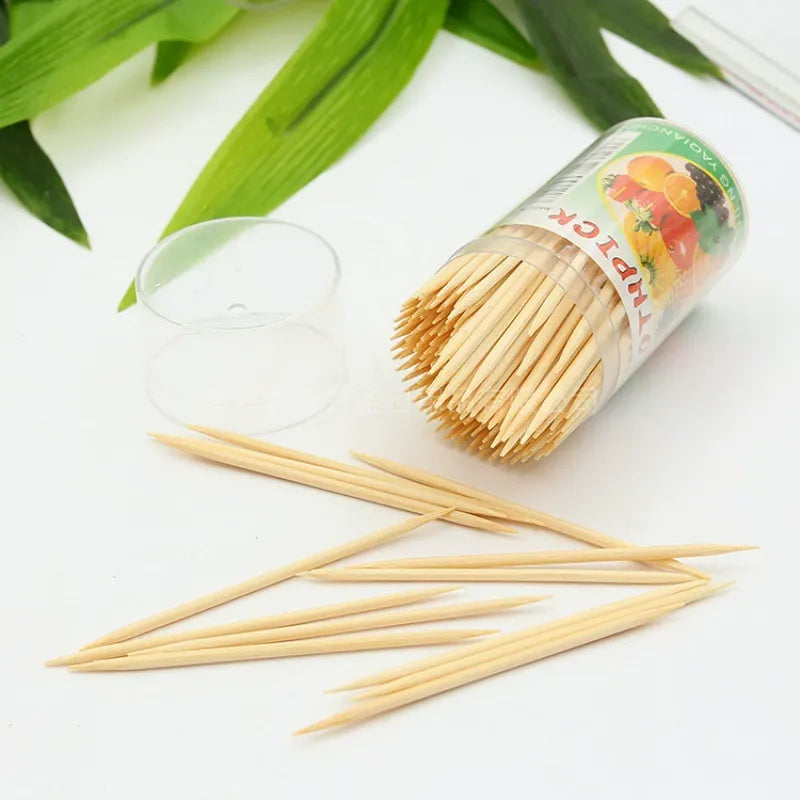 Bottled bamboo toothpick clear dispenser bottle spilling scattered picks