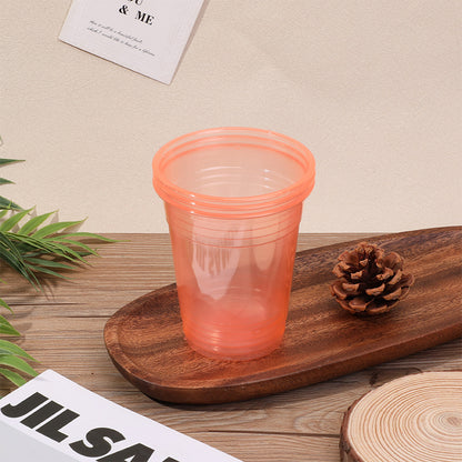 Colored disposable plastic party cups in pink green blue and orange