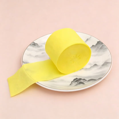 Crepe paper streamer bright yellow wound roll unrolled ribbon