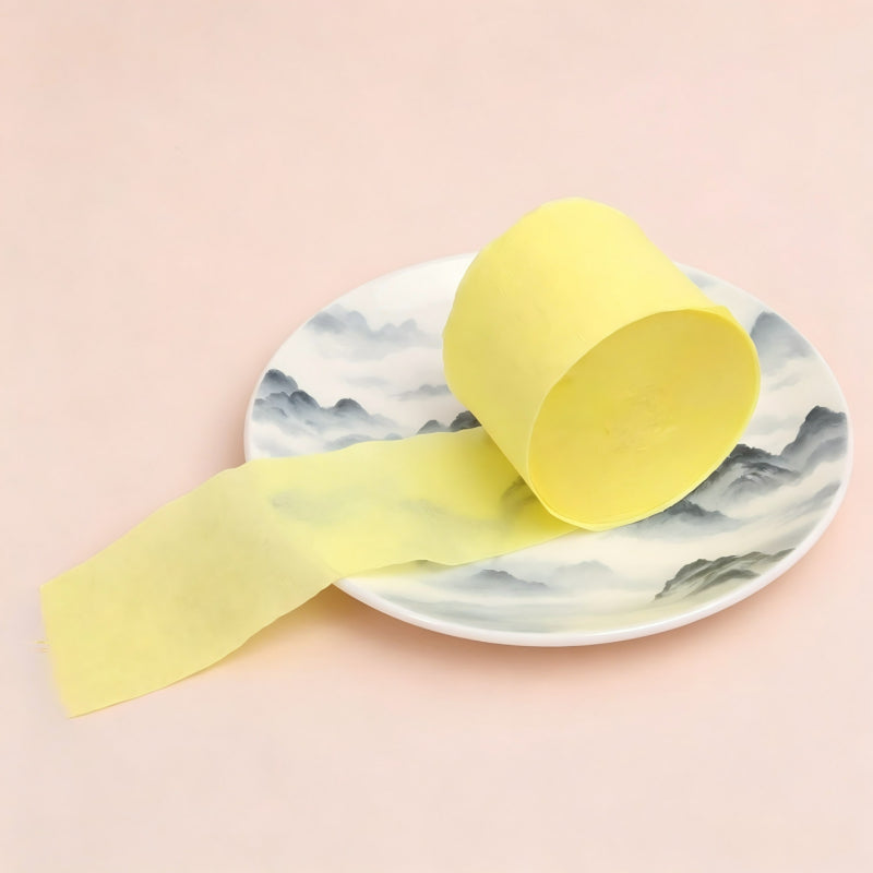 Crepe paper streamer pale yellow coiled roll extending strip