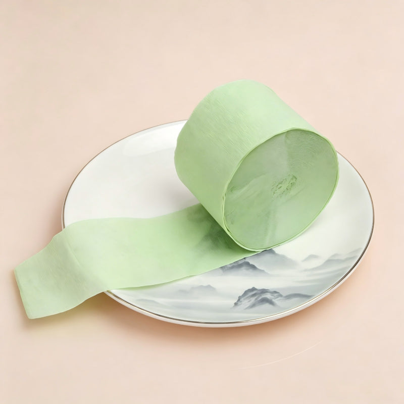 Crepe paper streamer fruit green coiled roll unrolled strip
