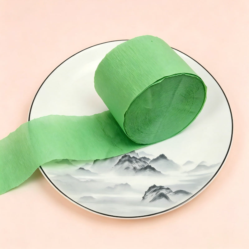 Crepe paper streamer vibrant green wound roll unrolled ribbon