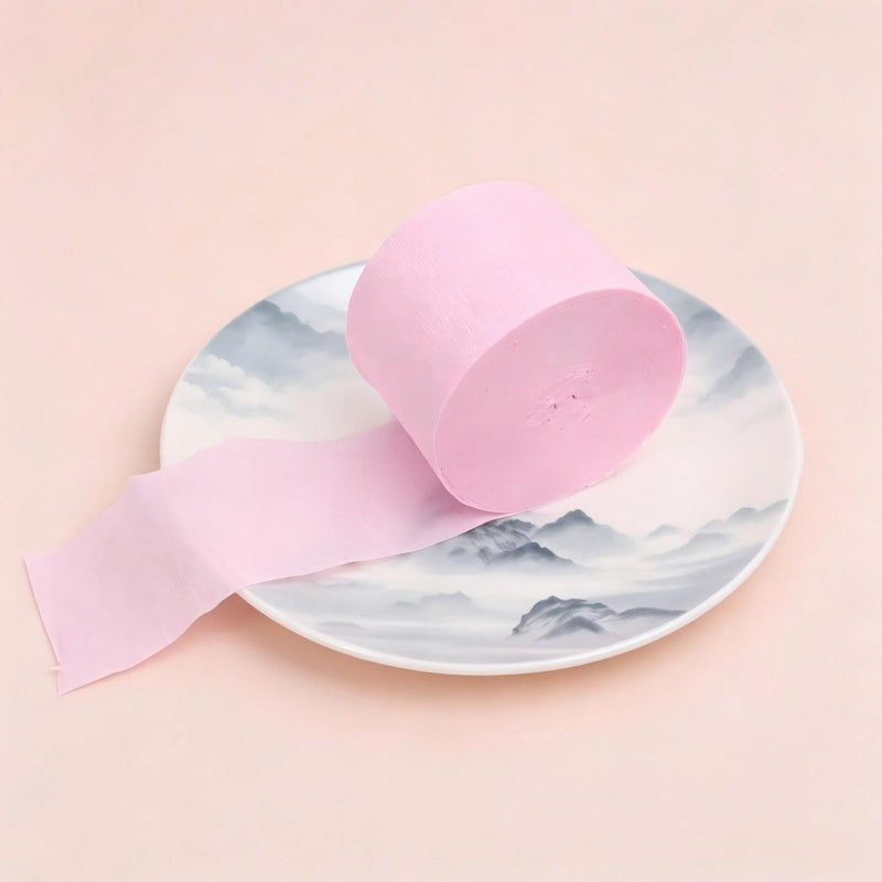 Crepe paper streamer light pink coiled roll extending strip