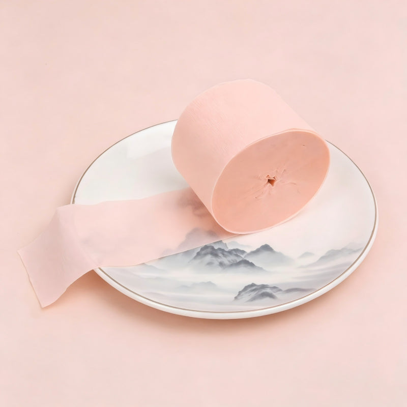 Crepe paper streamer peach pink coiled roll extending strip