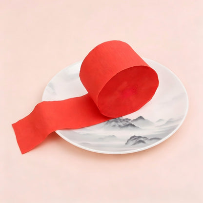 Crepe paper streamer bright red wound roll unrolled ribbon