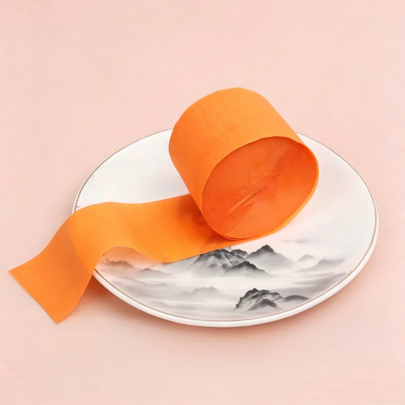 Crepe paper streamer vibrant orange compact roll extending ribbon