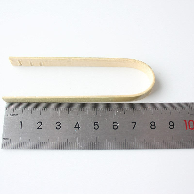 Bamboo food tong eight centimeter length beside steel ruler