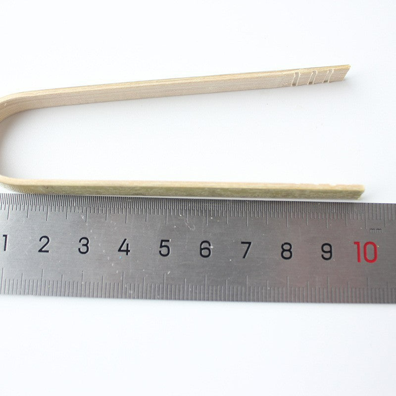 Bamboo food tong ten centimeter length beside measuring ruler