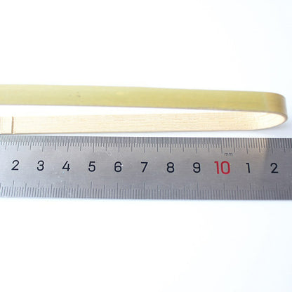 Bamboo food tong twelve centimeter size beside steel ruler