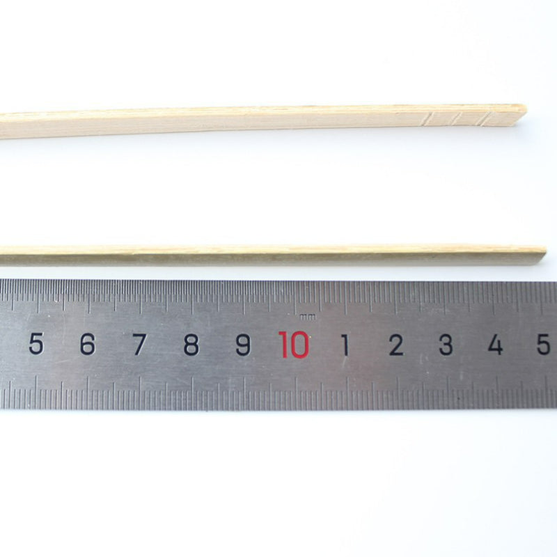 Bamboo food tong fifteen centimeter length beside steel ruler