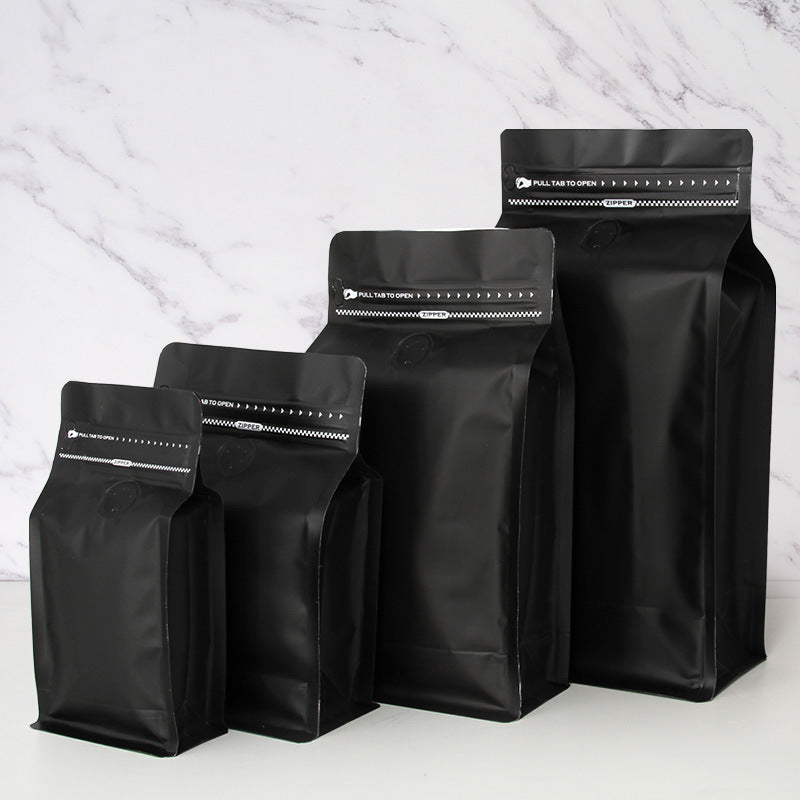Coffee valve bag matte black four capacity graduating lineup showing front degassing valve and zipper