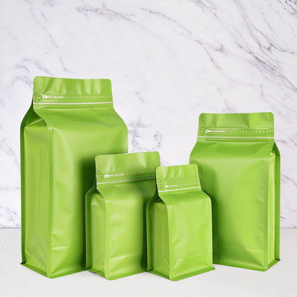 Coffee valve bag vibrant green four capacity graduating lineup showing flat bottom box construction