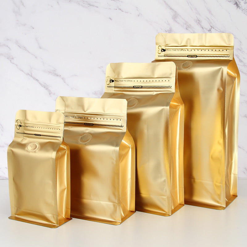 Coffee valve bag metallic gold four capacity graduating lineup showing front valve and pull tab zipper