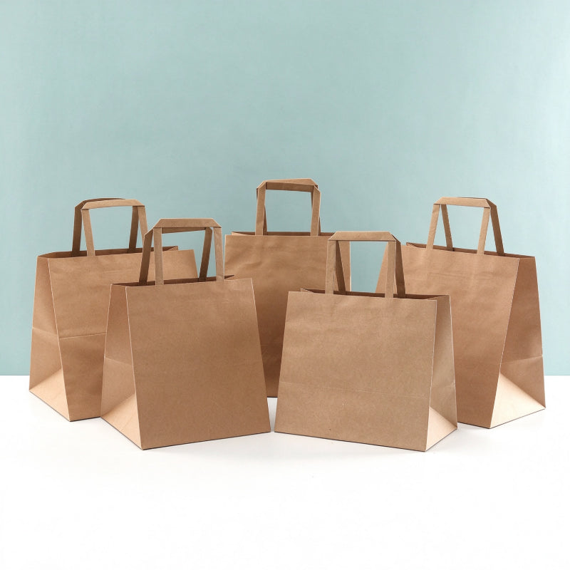 Flat handle kraft bag tiered group arrangement showing multiple commercial takeout sizes