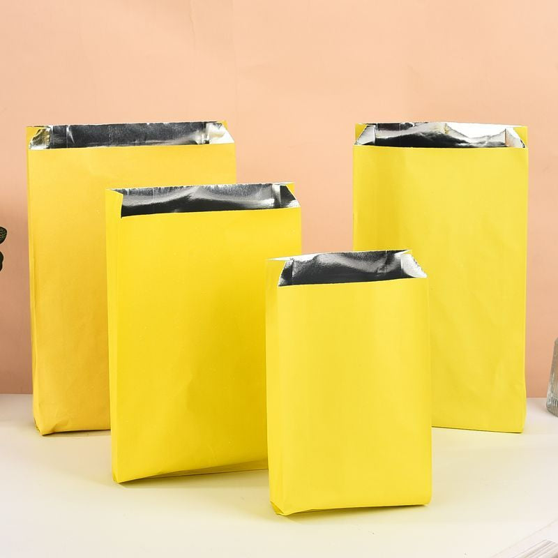 Foil-lined takeout bag bright yellow exterior with four graduated upright sizes showing side gusset and foil rim