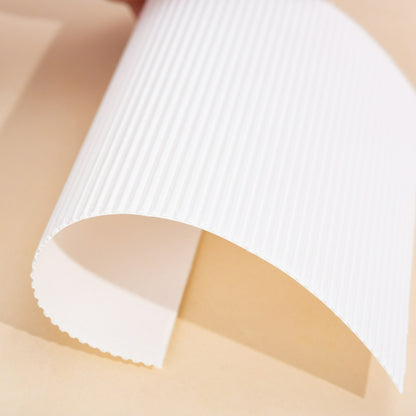 Fluted pizza liner curled sheet showing flexible double layer construction