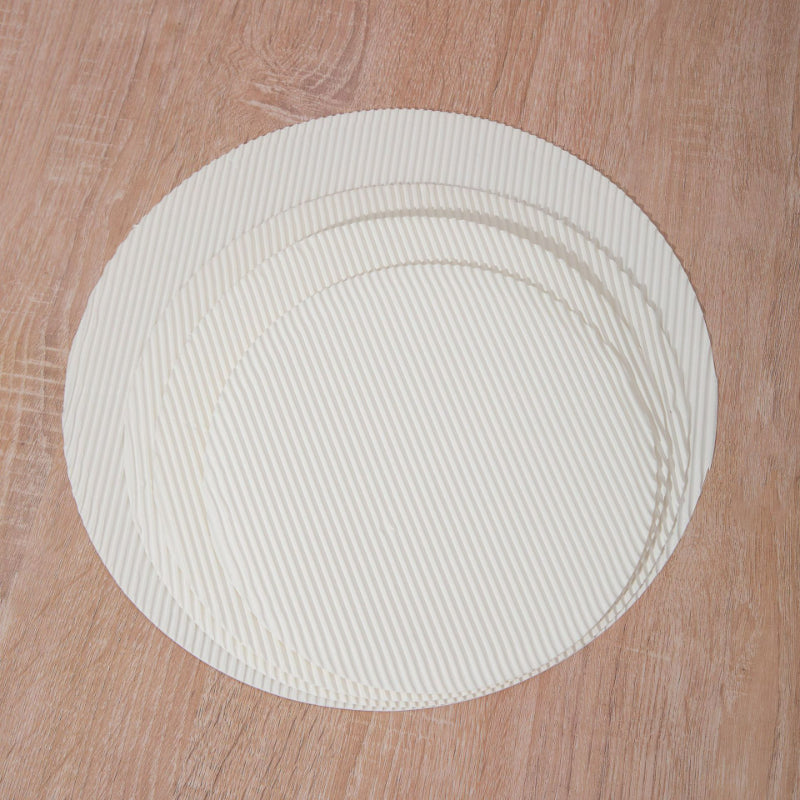 Fluted pizza liner round discs stacked showing circular contour