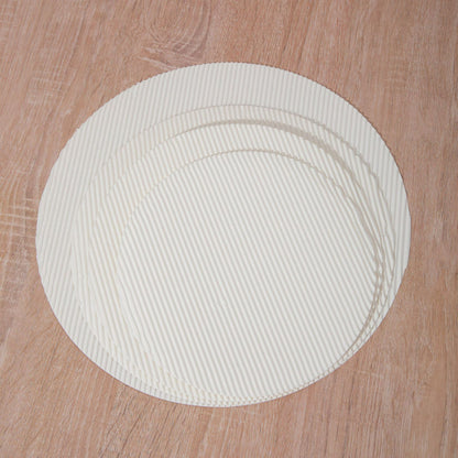 Fluted pizza liner round discs stacked showing circular contour