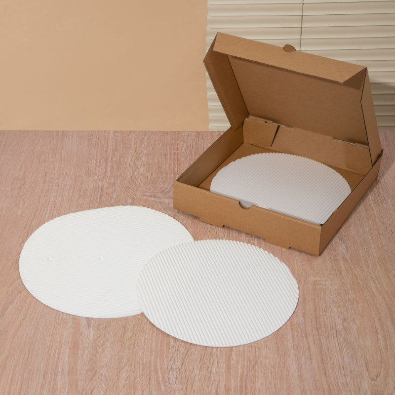 Fluted pizza liner round discs placed inside carton and laid flat