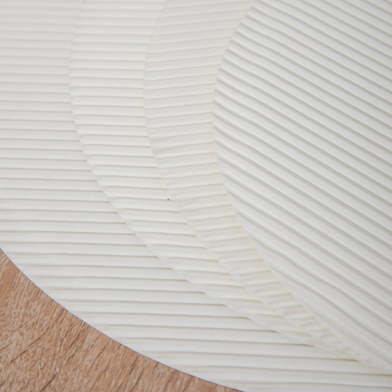Fluted pizza liner macro close up showing embossed wave ridges