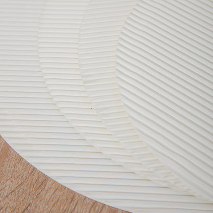Fluted pizza liner macro close up showing embossed wave ridges