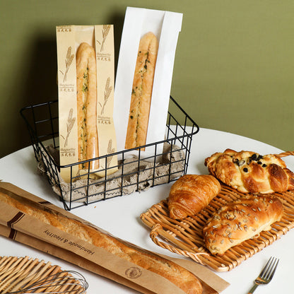 Kraft baguette bag short sleeves standing upright displaying wheat print and plain white