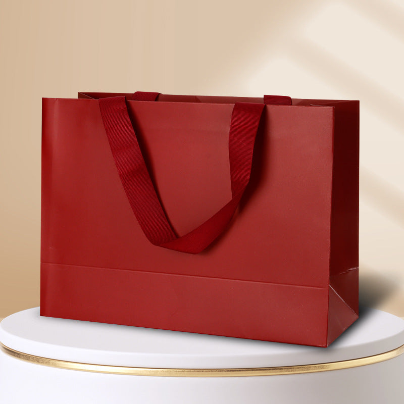 Kraft gift bag cherry red horizontal landscape finish with matching wide embedded ribbon handles