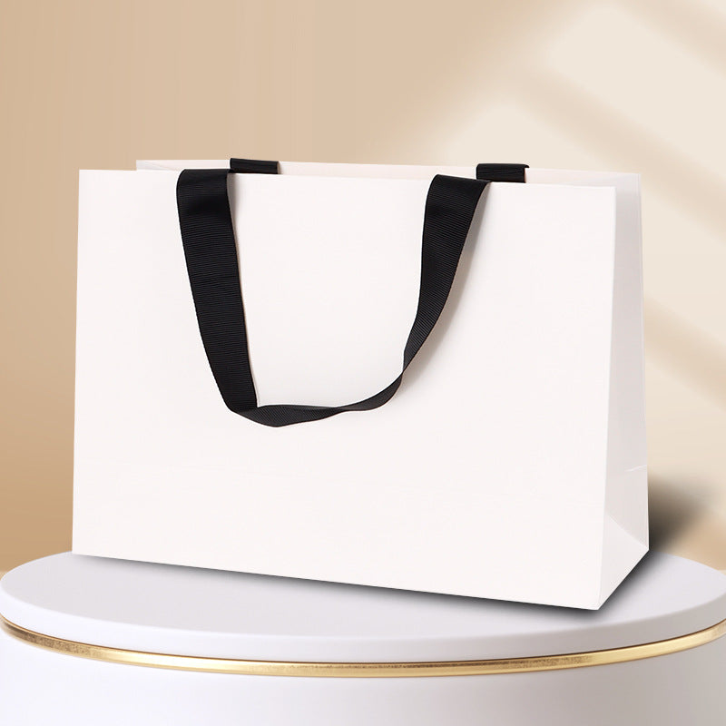 Kraft gift bag pure white horizontal landscape finish with contrasting black embedded ribbon handles