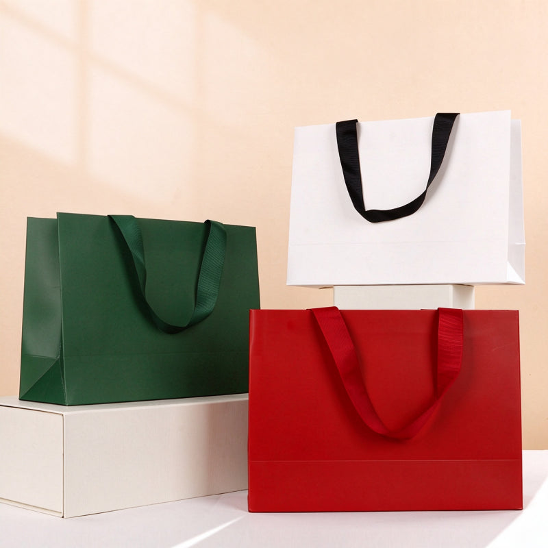 Kraft gift bag color trio display showing forest green cherry red and white horizontal bags