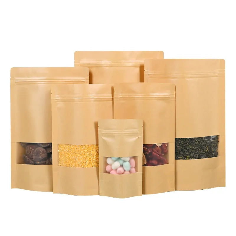 Kraft stand-up pouch tiered group of six brown pouches showing top tear notches and heat-sealable zip headers