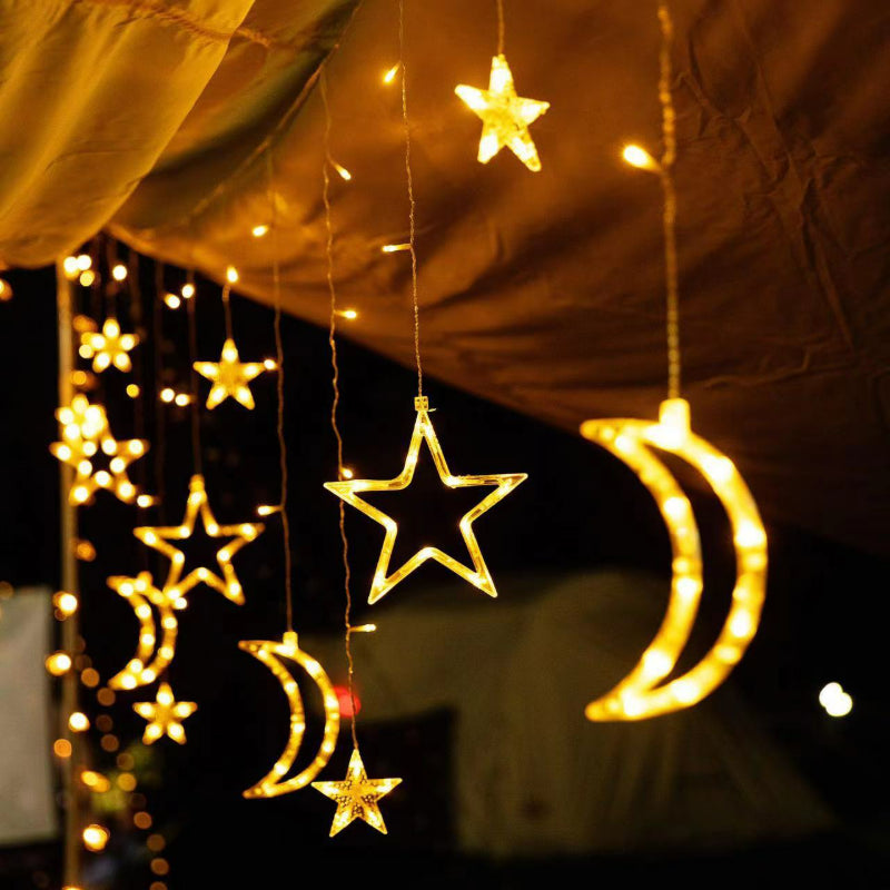 Curtain string lights warm white glowing stars and crescent moons