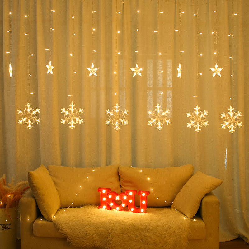 Curtain string lights warm white glowing snowflakes and star pendants