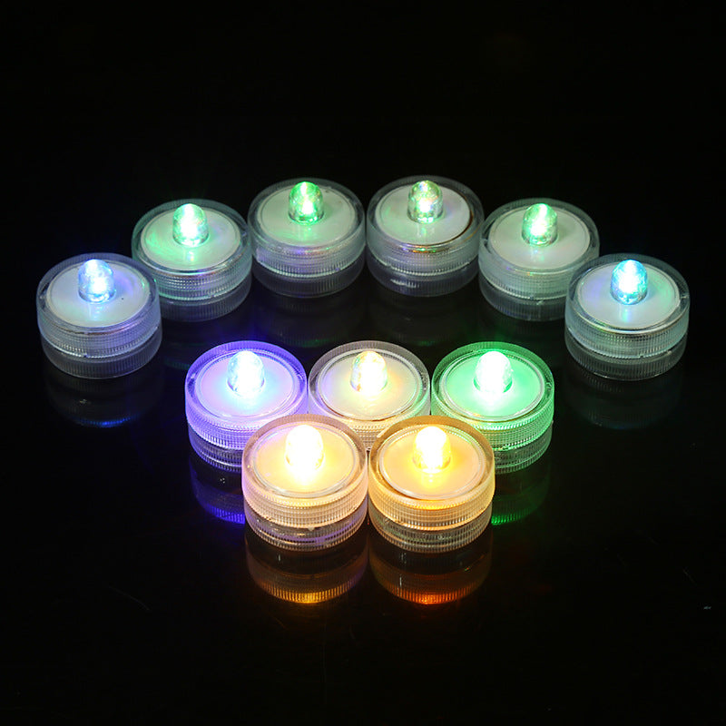Submersible waterproof LED tea light illuminated arc arrangement submerged in water