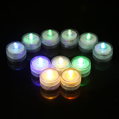Submersible waterproof LED tea light illuminated arc arrangement submerged in water