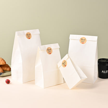 White kraft bag group arrangement showing multiple bag sizes with folded tops and seal stickers