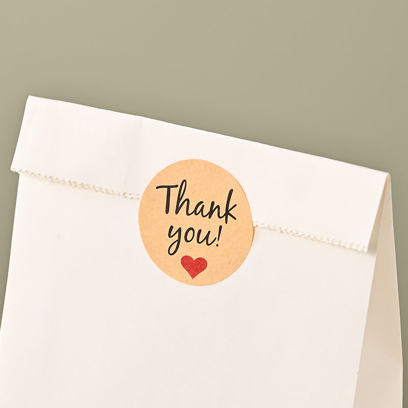 White kraft bag top opening folded down and sealed with circular adhesive label