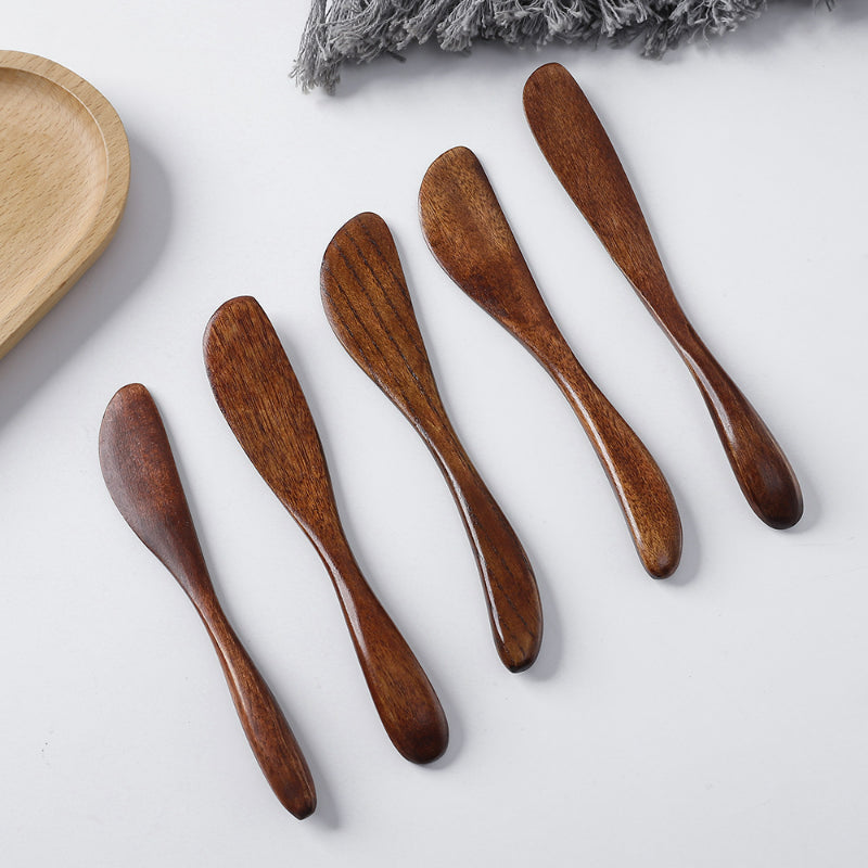 Wooden butter spreader angled lineup five dark polished knives
