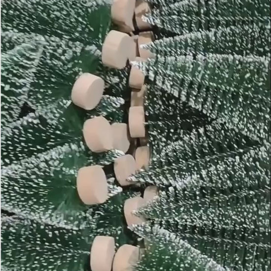Video showing frosted mini artificial Christmas trees