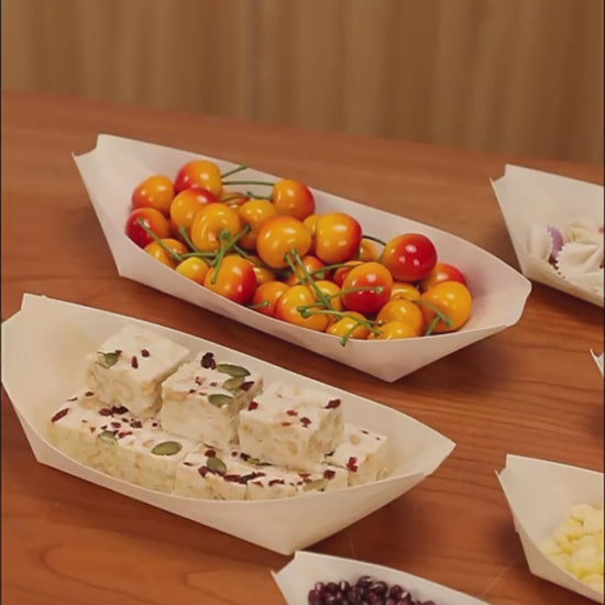 Video showing wooden boat-shaped serving trays